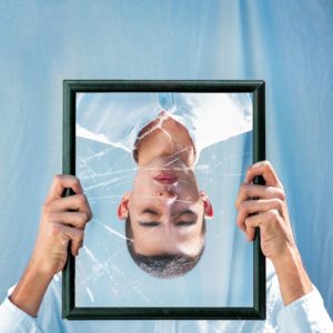 man in broken mirror